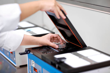 Picture2 | drmanishamehta.com Technician in a lab places a printed circuit board into a flatbed scanner for inspection